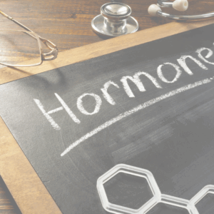 A chalk board with the word hormones written on it